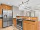 Spacious stainless steel refrigerator and oven complement the light wood cabinets and countertops at 708 E Patterson St, Tampa, FL 33604