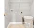 Laundry room with tile flooring, wire shelf, white walls, and washer hookups at 708 E Patterson St, Tampa, FL 33604