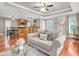 Bright open-concept living area with wood floors, neutral decor, and views into the kitchen at 708 E Patterson St, Tampa, FL 33604