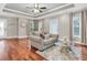 Inviting living room with wood floors, a cozy sofa, and natural light from multiple windows at 708 E Patterson St, Tampa, FL 33604