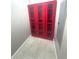 Bright red storage cabinet with glass doors adds a pop of color to the room at 708 E Patterson St, Tampa, FL 33604