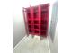 Open, bright red storage cabinet with ample shelving for organization and display at 708 E Patterson St, Tampa, FL 33604