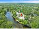 Aerial view showing home along the river, including lush trees and vegetation at 713 Argyle Pl, Temple Terrace, FL 33617