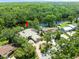 Aerial view of the property showing the home nestled among lush trees and a river at 713 Argyle Pl, Temple Terrace, FL 33617