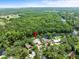 Aerial view of the waterfront home nestled amidst lush trees and landscaping at 713 Argyle Pl, Temple Terrace, FL 33617