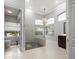 Bathroom featuring a glass shower enclosure, stylish vanity, and arched windows at 713 Argyle Pl, Temple Terrace, FL 33617