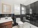 Modern bathroom featuring a glass shower, mirrored vanity, and contrasting dark tile at 713 Argyle Pl, Temple Terrace, FL 33617