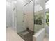 Modern bathroom offering a glass-enclosed shower with dual showerheads and tiled flooring at 713 Argyle Pl, Temple Terrace, FL 33617