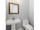 Bathroom with a white sink, toilet, and gold-trimmed mirror at 713 Argyle Pl, Temple Terrace, FL 33617