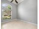 Bedroom featuring a window, tile flooring, and neutral color palette at 713 Argyle Pl, Temple Terrace, FL 33617