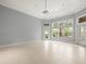 Bedroom with neutral walls, tile flooring, and a large window at 713 Argyle Pl, Temple Terrace, FL 33617