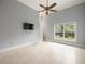 Bedroom with tile flooring, ceiling fan, neutral paint, and a large window with outdoor views at 713 Argyle Pl, Temple Terrace, FL 33617