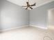 Empty bedroom with tile floor, ceiling fan, and neutral paint perfect for customization at 713 Argyle Pl, Temple Terrace, FL 33617