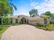 Charming exterior elevation view of home featuring an attached garage and manicured lawn at 713 Argyle Pl, Temple Terrace, FL 33617