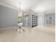 Bright and airy foyer with elegant lighting fixtures, tile flooring, and a glass table at 713 Argyle Pl, Temple Terrace, FL 33617