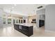 Gourmet kitchen features large kitchen island, stainless appliances, and views of the backyard at 713 Argyle Pl, Temple Terrace, FL 33617