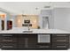 Kitchen island boasts a modern stainless steel dishwasher, sink, and ample storage at 713 Argyle Pl, Temple Terrace, FL 33617