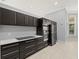 A kitchen features stainless steel appliances and dark cabinets at 713 Argyle Pl, Temple Terrace, FL 33617