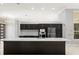Modern kitchen features stainless steel appliances, dark cabinets, and a large center island at 713 Argyle Pl, Temple Terrace, FL 33617