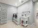 Well-equipped laundry room with washer, dryer, wash basin and storage at 713 Argyle Pl, Temple Terrace, FL 33617
