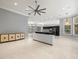 Open living room with tile flooring, windows, and island with white cabinets at 713 Argyle Pl, Temple Terrace, FL 33617