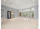 Large living room featuring tile flooring, bright windows, and access to the backyard at 713 Argyle Pl, Temple Terrace, FL 33617