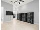 This living room boasts tile flooring, recessed lighting, a ceiling fan, and custom built-in display shelving at 713 Argyle Pl, Temple Terrace, FL 33617