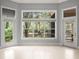 Bright living room showcasing tile floors and a large window overlooking the lush greenery at 713 Argyle Pl, Temple Terrace, FL 33617