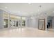 Large living room features bay windows, light colored walls, and easy access to the kitchen at 713 Argyle Pl, Temple Terrace, FL 33617