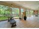 Large screened-in porch area with outdoor kitchen, tile floors and waterfront views at 713 Argyle Pl, Temple Terrace, FL 33617