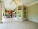Expansive screened porch area with an outdoor kitchen, tile floors, and natural light at 713 Argyle Pl, Temple Terrace, FL 33617