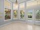 Sunroom with windows that provide plenty of natural light at 713 Argyle Pl, Temple Terrace, FL 33617
