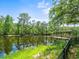 Waterfront backyard with a private dock, lush landscaping, and picturesque views at 713 Argyle Pl, Temple Terrace, FL 33617