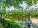 Backyard view of the waterfront featuring lush greenery and a private dock at 713 Argyle Pl, Temple Terrace, FL 33617
