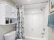 Clean bathroom with a tub, shower, and storage cabinet, offering convenience and functionality at 809 Bahia Del Sol Dr # 72, Ruskin, FL 33570