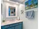 Bright bathroom featuring a granite vanity, large mirror, and coastal decor at 809 Bahia Del Sol Dr # 72, Ruskin, FL 33570