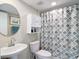 Bathroom featuring a round mirror, storage cabinet, and patterned shower curtain at 809 Bahia Del Sol Dr # 72, Ruskin, FL 33570