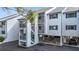 Condo exterior featuring private entrances, open-air staircases, and parking at 809 Bahia Del Sol Dr # 72, Ruskin, FL 33570