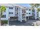 Exterior view of condos featuring private covered parking and staircases to private entrances at 809 Bahia Del Sol Dr # 72, Ruskin, FL 33570