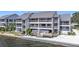 Waterfront condo with balconies, staircase access, manicured landscaping, and waterfront access at 809 Bahia Del Sol Dr # 72, Ruskin, FL 33570