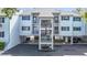 Exterior view of condos featuring private covered parking and staircases to private entrances at 809 Bahia Del Sol Dr # 72, Ruskin, FL 33570