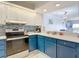 Stylish kitchen with white countertops, blue cabinets, and a glass tile backsplash at 809 Bahia Del Sol Dr # 72, Ruskin, FL 33570