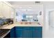 View from kitchen features modern appliances, blue cabinets, and a peek into the living space at 809 Bahia Del Sol Dr # 72, Ruskin, FL 33570