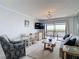 Cozy living room features stylish seating, TV, and sliding doors with a scenic view at 809 Bahia Del Sol Dr # 72, Ruskin, FL 33570