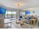 Bright living room featuring a striped sofa, modern lighting and scenic balcony views at 809 Bahia Del Sol Dr # 72, Ruskin, FL 33570