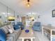 Open living area showcasing a striped sofa, accent chairs, and easy access to kitchen and dining at 809 Bahia Del Sol Dr # 72, Ruskin, FL 33570
