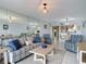 Cozy living room with mirror wall, comfortable seating, and open access to dining area at 809 Bahia Del Sol Dr # 72, Ruskin, FL 33570