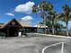 Exterior view of Sunset Bar & Grille with palm trees and tropical landscaping around parking area at 809 Bahia Del Sol Dr # 72, Ruskin, FL 33570