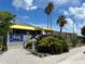 Exterior view of Hooks Waterfront Bar & Grill, featuring tropical landscaping and ample parking at 809 Bahia Del Sol Dr # 72, Ruskin, FL 33570