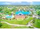 Aerial view of a clubhouse showing the building, golf course, and pool at 9027 Merrimoor Blvd, Seminole, FL 33777